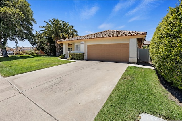 mediterranean / spanish-style home with a front yard and a garage