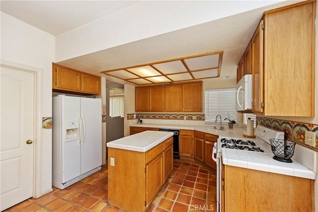 kitchen with white appliances, tile counters, a kitchen island, and tasteful backsplash