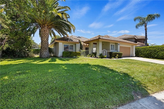 mediterranean / spanish-style home featuring a front yard and a garage