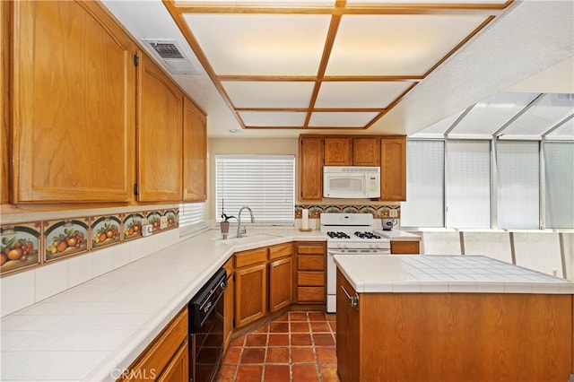 kitchen featuring dark tile patterned flooring, tile counters, tasteful backsplash, sink, and white appliances