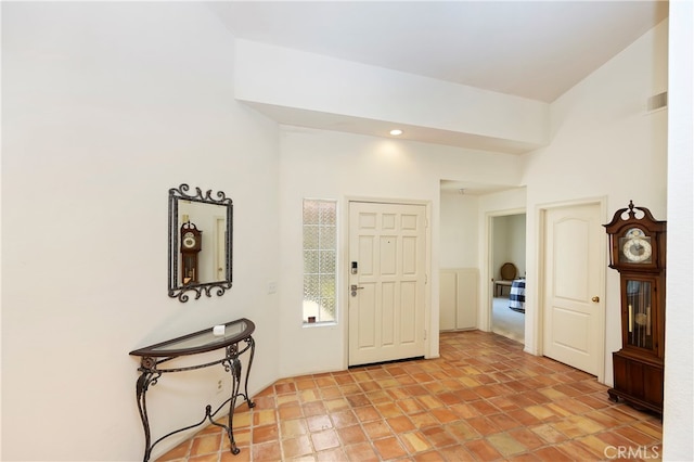 foyer featuring a towering ceiling