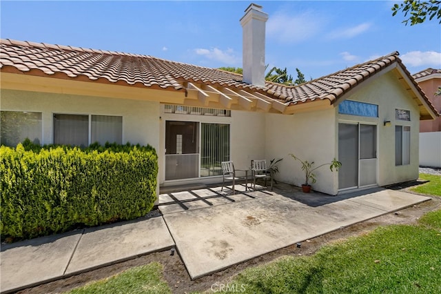 back of property featuring a patio area