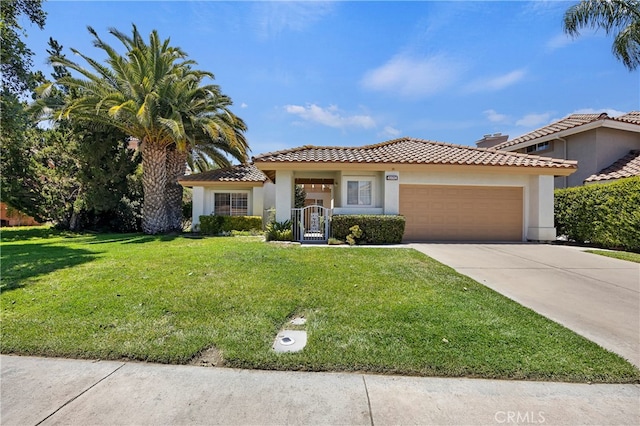 mediterranean / spanish-style house with a front yard and a garage