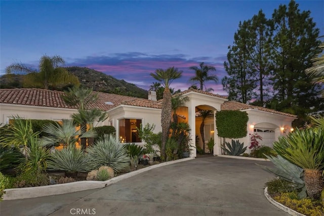 mediterranean / spanish house with a garage