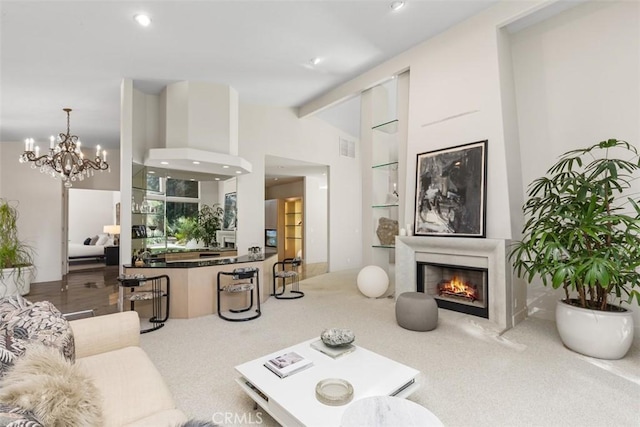 living room featuring a fireplace, carpet, vaulted ceiling with beams, and a notable chandelier