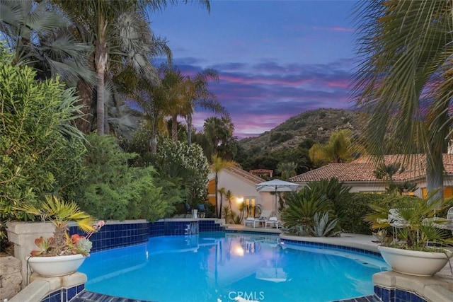 view of pool at dusk