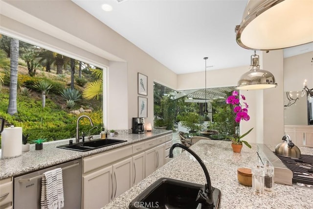 kitchen featuring a wealth of natural light, dishwasher, and sink