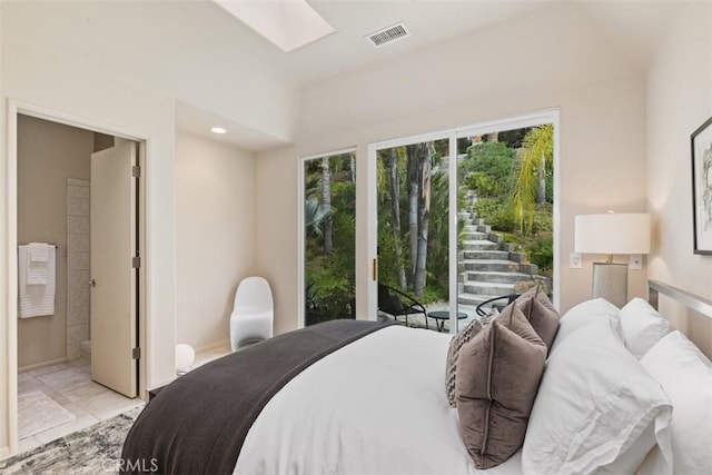 bedroom featuring connected bathroom and access to outside