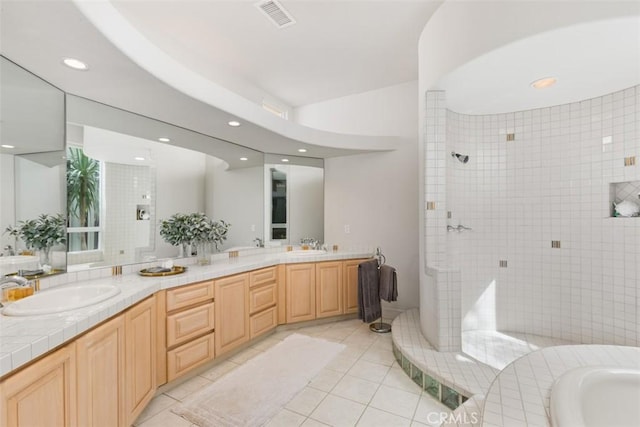 bathroom featuring tile patterned floors, vanity, and independent shower and bath