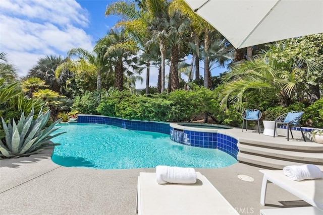 view of pool featuring an in ground hot tub and a patio