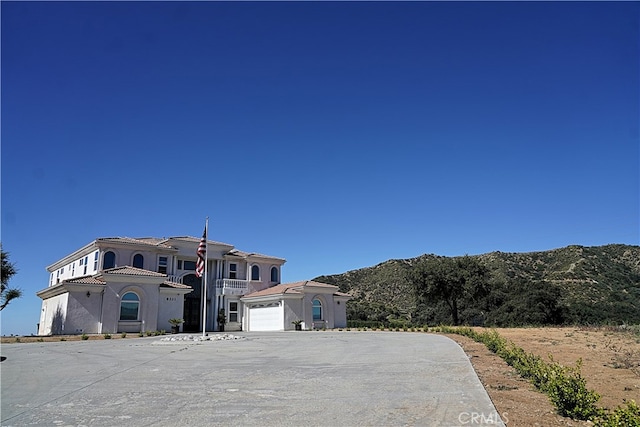 view of front facade with a mountain view and a garage