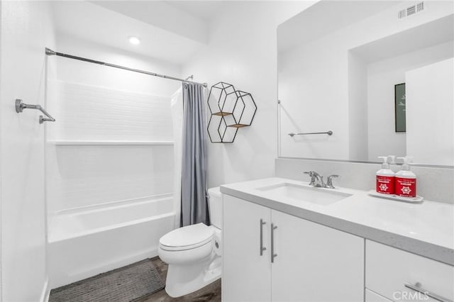 full bathroom featuring hardwood / wood-style flooring, vanity, toilet, and shower / bath combo with shower curtain