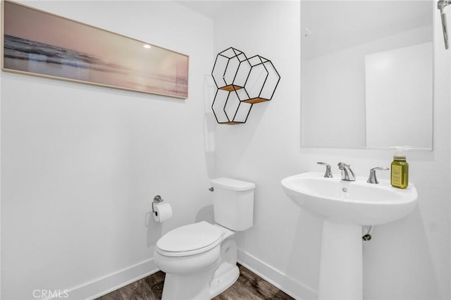 bathroom featuring sink, hardwood / wood-style floors, and toilet