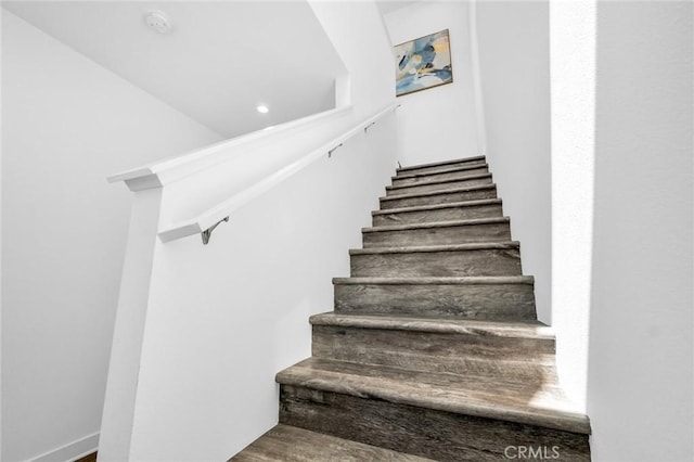 staircase featuring wood-type flooring