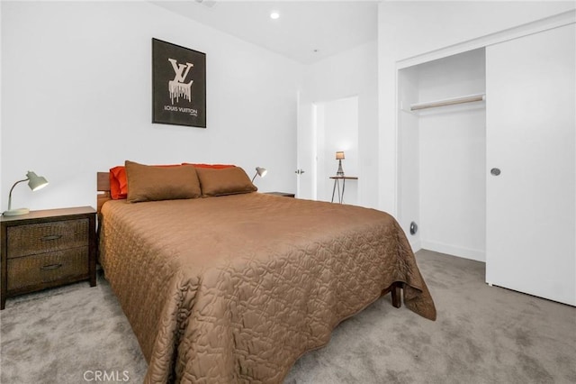 bedroom with light carpet and a closet