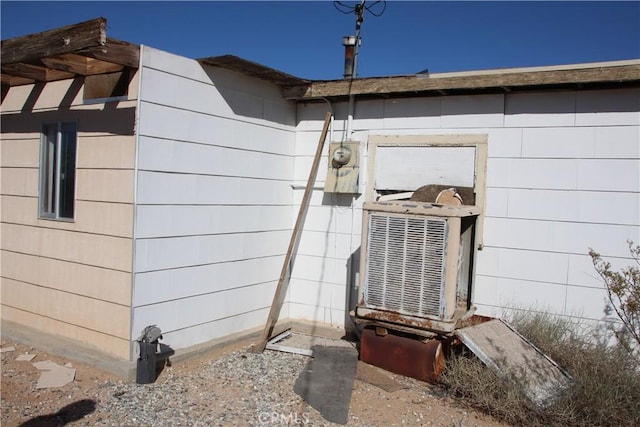 exterior details featuring electric meter and cooling unit