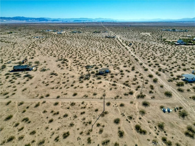 birds eye view of property with a mountain view and a desert view