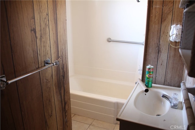 bathroom featuring tile patterned flooring, shower / washtub combination, and vanity