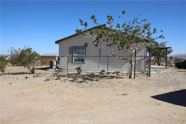 view of side of property featuring fence and central air condition unit