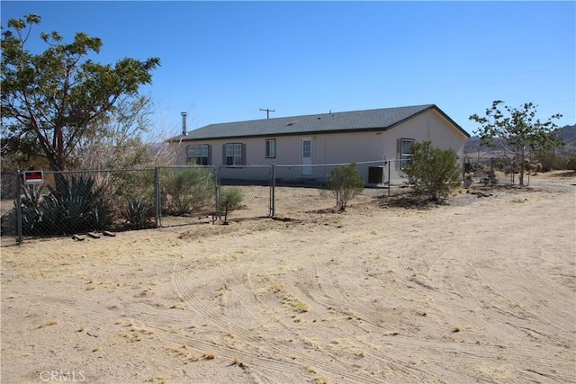 rear view of property with fence