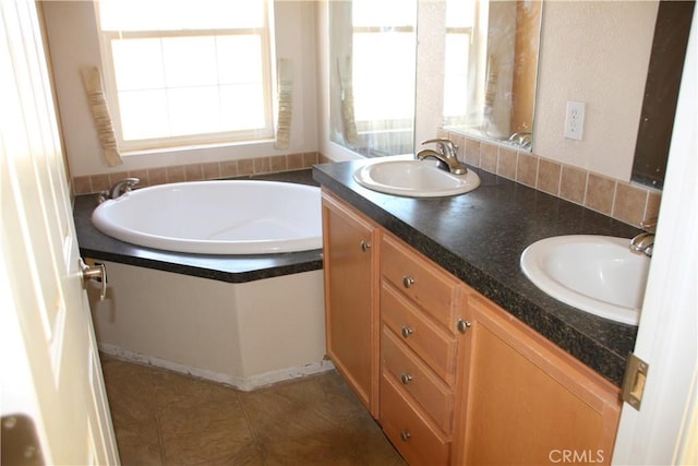 full bathroom with a garden tub, double vanity, a sink, and tile patterned floors