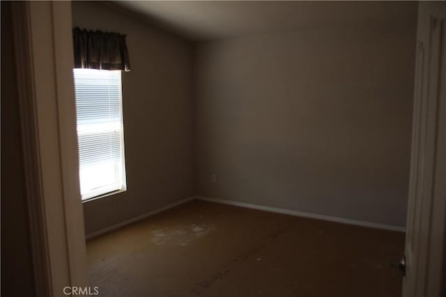 spare room with baseboards