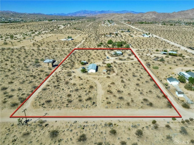 birds eye view of property featuring a mountain view and a desert view