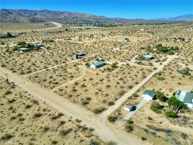 drone / aerial view featuring a desert view and a mountain view