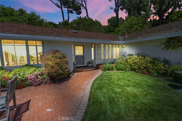 8 Quail Ridge Rd S, Rolling Hills, CA 90274 - exterior entry at dusk with a lawn