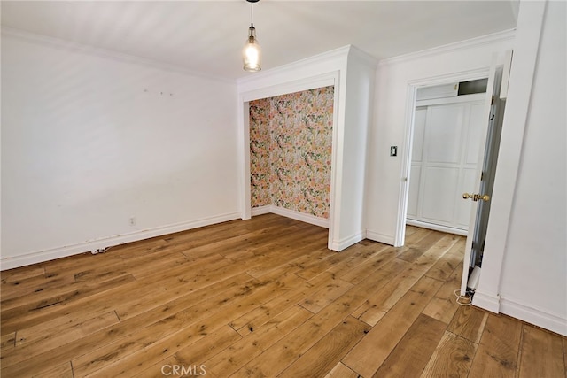 spare room with light hardwood / wood-style flooring and ornamental molding