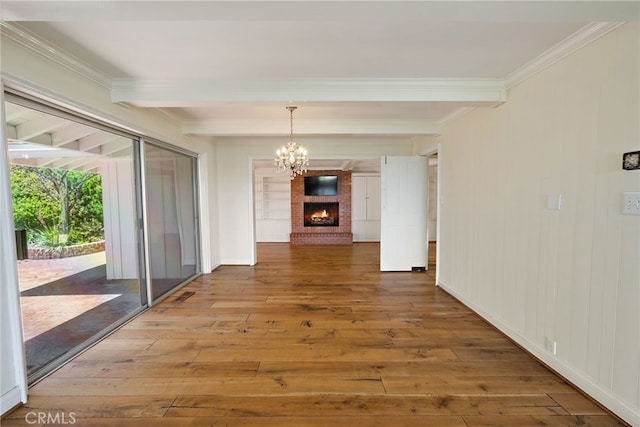 8 Quail Ridge Rd S, Rolling Hills, CA 90274 - unfurnished dining area featuring beamed ceiling, wood-type flooring, crown molding, a chandelier, and a brick fireplace