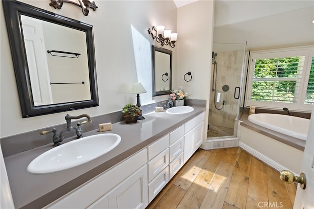 bathroom featuring vanity, a notable chandelier, shower with separate bathtub, and wood-type flooring