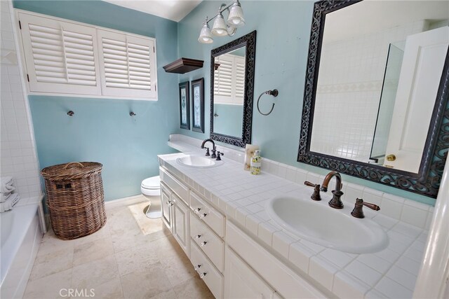 8 Quail Ridge Rd S, Rolling Hills, CA 90274 - bathroom with toilet, double vanity, a tub to relax in, and baseboards