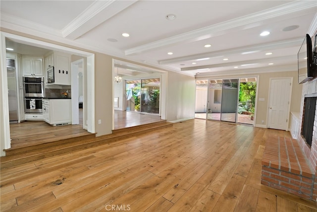 unfurnished living room featuring a healthy amount of sunlight and light wood-type flooring