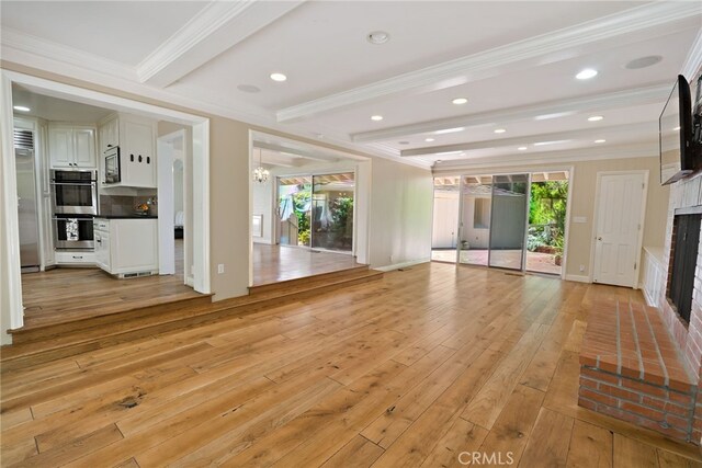 8 Quail Ridge Rd S, Rolling Hills, CA 90274 - unfurnished living room featuring a fireplace, light wood-type flooring, crown molding, beamed ceiling, and recessed lighting