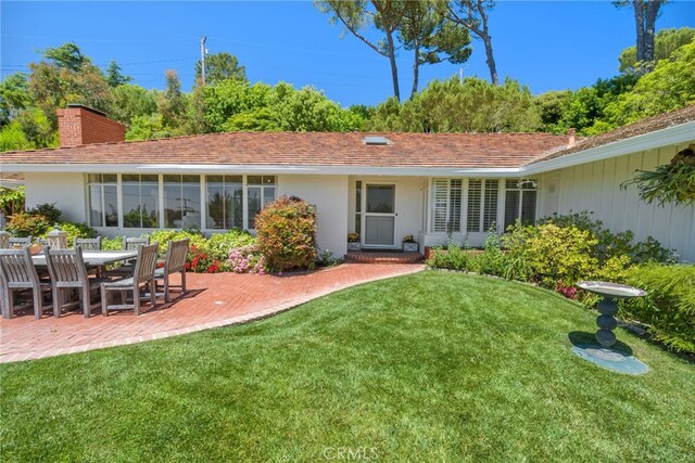 8 Quail Ridge Rd S, Rolling Hills, CA 90274 - rear view of property with a lawn, a patio, and a chimney