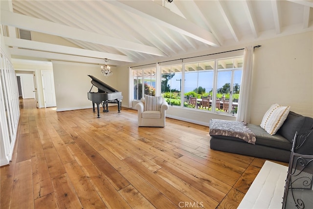 living room with a notable chandelier, light hardwood / wood-style flooring, and vaulted ceiling with beams