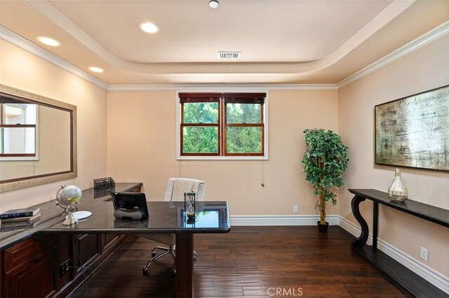 office area with a raised ceiling, crown molding, and dark wood-type flooring