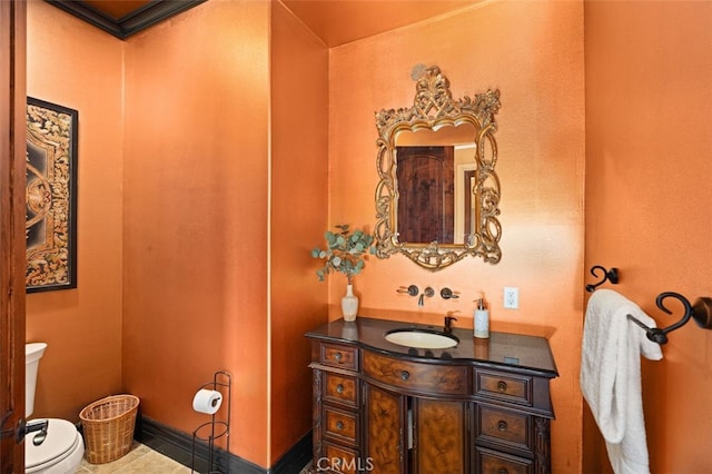 bathroom with tile patterned flooring, vanity, and toilet