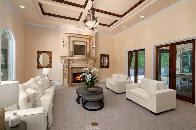 living room featuring a high end fireplace, coffered ceiling, french doors, and crown molding