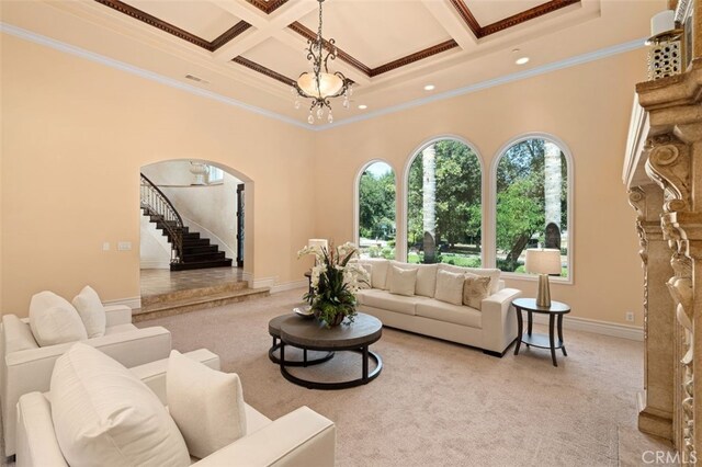 carpeted living room featuring ornamental molding, coffered ceiling, and beam ceiling