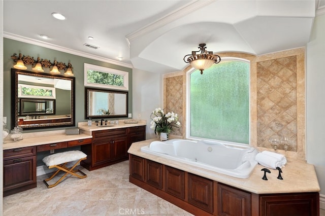 bathroom with a bathtub, ornamental molding, and vanity