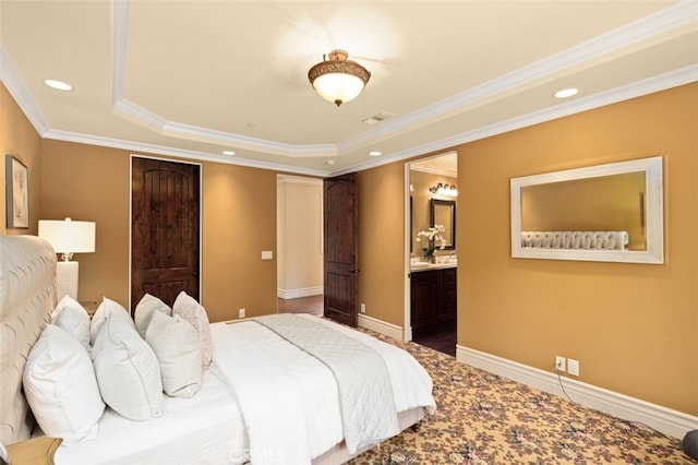 bedroom with ornamental molding, a raised ceiling, and ensuite bathroom