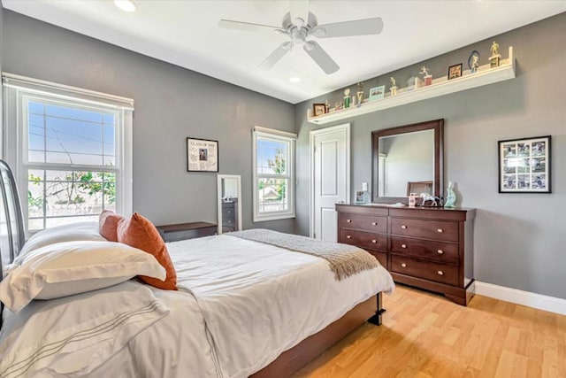 bedroom with ceiling fan and light wood-type flooring