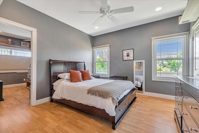 bedroom with ceiling fan and light hardwood / wood-style floors