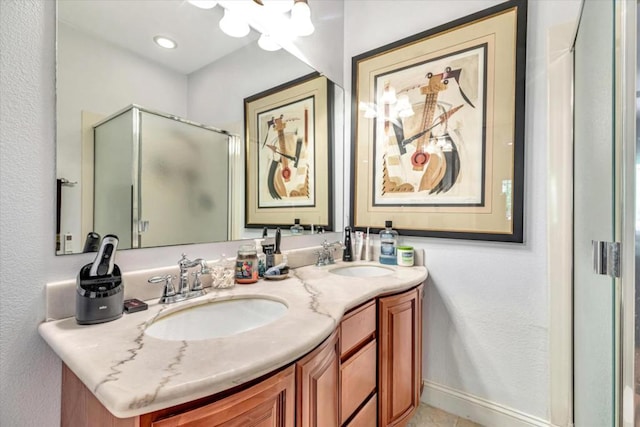 bathroom featuring an enclosed shower and vanity