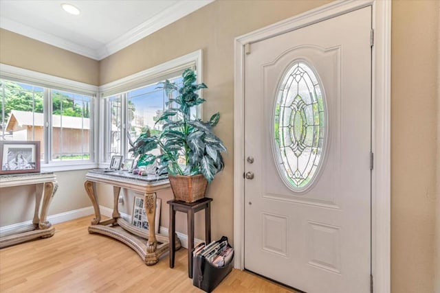 entrance foyer with crown molding and light hardwood / wood-style floors