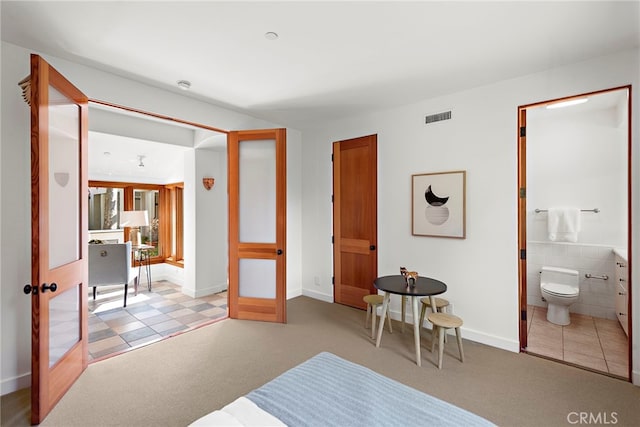 bedroom featuring french doors, carpet flooring, and visible vents