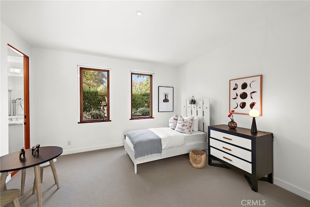 carpeted bedroom featuring baseboards