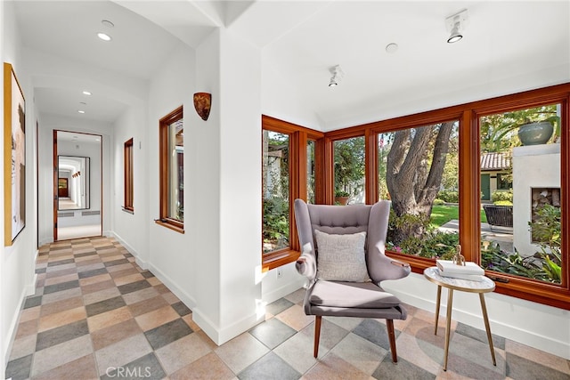 interior space featuring lofted ceiling, baseboards, and recessed lighting